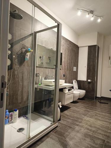 a bathroom with a shower and a sink and a toilet at Stella Apartment in Palermo