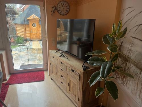 a bathroom with a wooden dresser and a mirror at Wellness Oase auf dem Land in Buttstädt