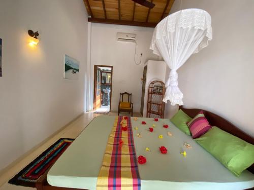 a bedroom with a large bed with flowers on it at River Shadow Villa in Bentota