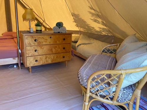 a bedroom with a bed and a dresser with a tent at Winter Glamping Tent Hovfjallet Vitsand in Torsby