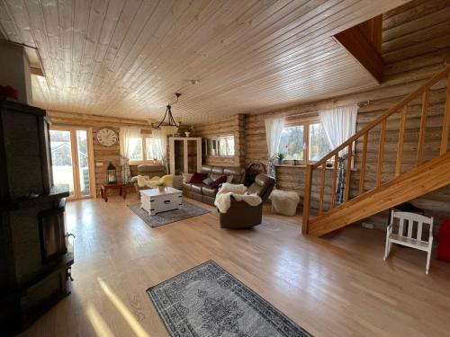 a living room with wooden walls and a wooden ceiling at Villa Uuekadaka in Põhja