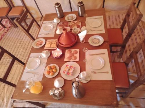 an overhead view of a table with breakfast food at Merzouga Wildlife Desert Camp in Merzouga