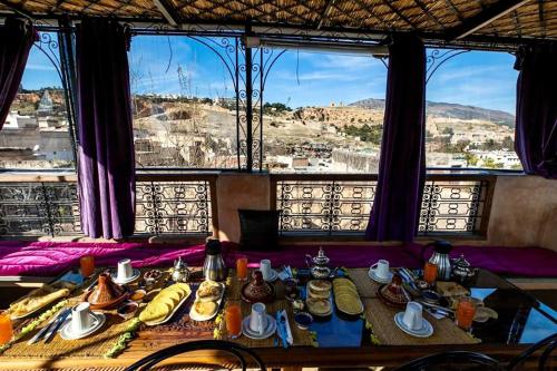 a table with food on it in front of a window at DAR Naima in Fez