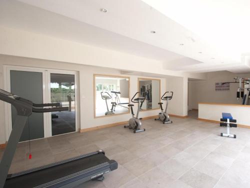 a gym with treadmills and ellipticals in a room at Spacieux appt 2ch 50m de la plage in Cap Malheureux