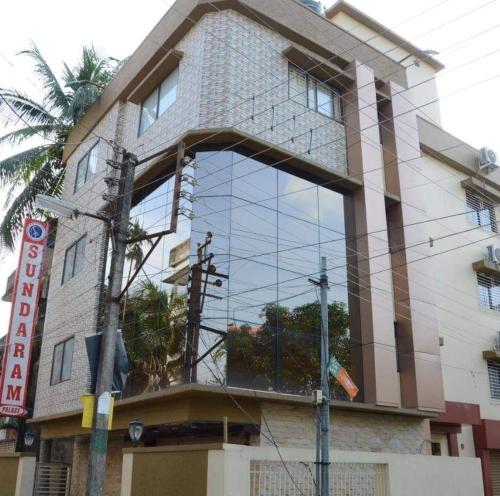 a building with a large window on the side of it at Hotel Sundaram Palace in Siliguri