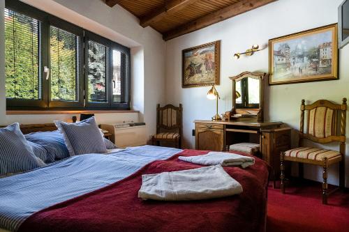 a bedroom with a bed and a desk and a mirror at Hotel No.16 in Bratislava