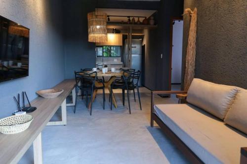 a living room with a couch and a table at Casa Salga Patacho F003 - Rota Ecológica de São Miguel dos Milagres in Pôrto de Pedras