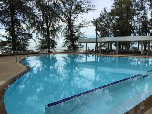 a large swimming pool with blue water at Sandy Beach Condo 17D in Cha Am