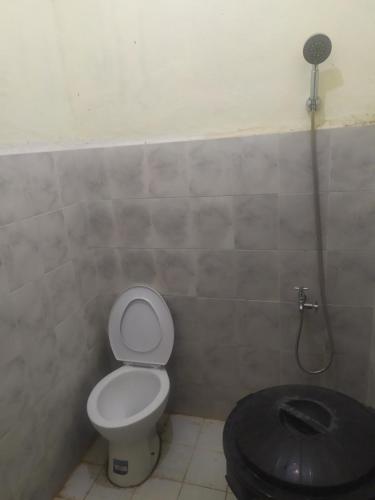a bathroom with a toilet and a shower at SAPO SAPO in Karema