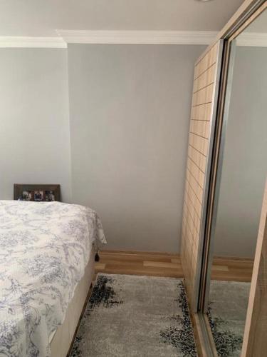 a bedroom with a bed and a walk in closet at Vita Suit in Küçükköy