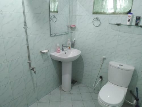a bathroom with a toilet and a sink and a shower at 4Seasons Holiday Home in Ratnapura