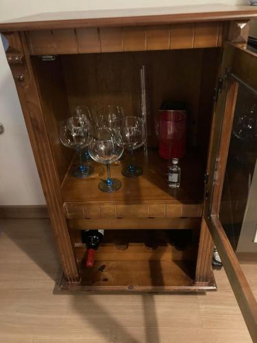 a wooden cabinet with wine glasses on it at Cidades Portuguesas in Florianópolis