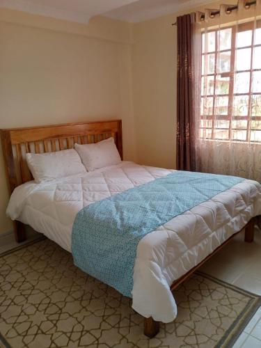 מיטה או מיטות בחדר ב-Apartment next to Cravers, Thika