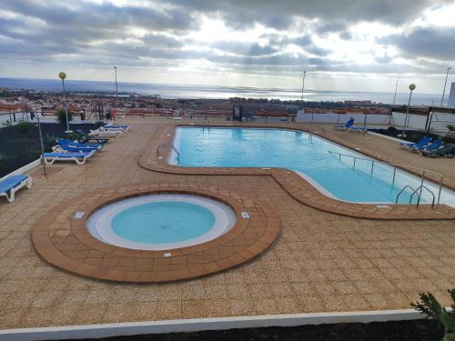 a large swimming pool on top of a building at Casa Yanira in Caleta De Fuste