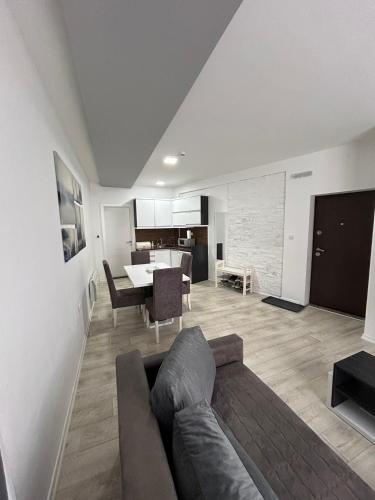 a living room with a couch and a table at White Apartman Kopaonik in Kopaonik
