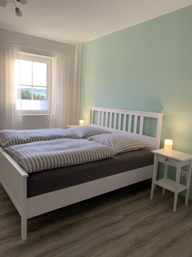 a bedroom with a large bed and a window at Eifler - Sonnenfels in Gerolstein