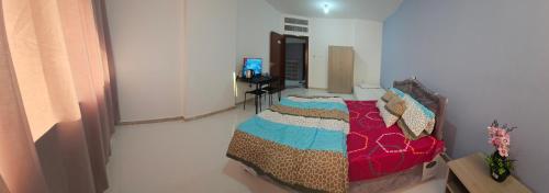 a bedroom with a bed and a desk in it at Baith al jannah in Abu Dhabi