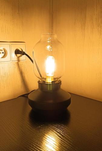 a lamp on a table with a light on it at Apartaments Gory in Niedzica Zamek