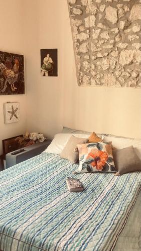 a bedroom with a bed with a blue striped comforter at Lily CA in Cagliari