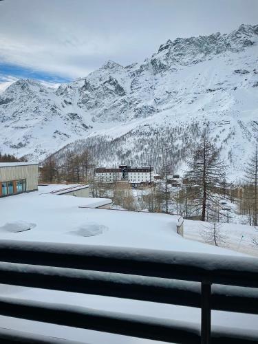 a view of a snow covered mountain from a window at Ski paradise - Cielo alto Cervinia in Breuil-Cervinia
