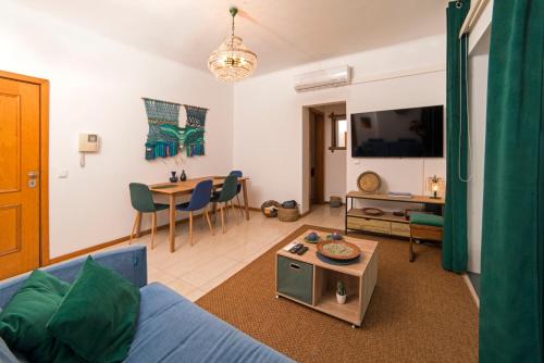 uma sala de estar com um sofá azul e uma mesa em The Terrace em Ponta Delgada