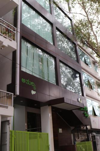 a building with a sign on the side of it at Athulya Stays in Bengaluru