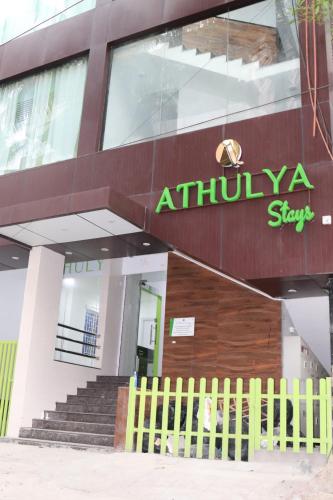 a building with a yellow fence in front of it at Athulya Stays in Bengaluru