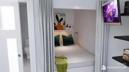 a small room with a bed with pillows on it at Croissant de Lune Studio Moon in Bagard