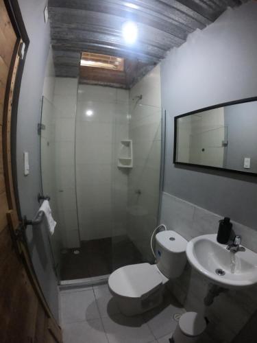 a bathroom with a shower and a toilet and a sink at Casa Figueroa in Puerto Colombia