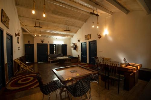 a room with a table and chairs in a building at The Green Casa - Families Only in Ooty