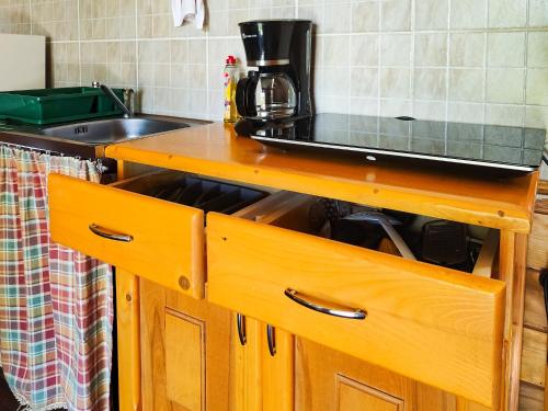 a kitchen with a wooden counter top with a sink at Alpine Escape Studios in Măgura