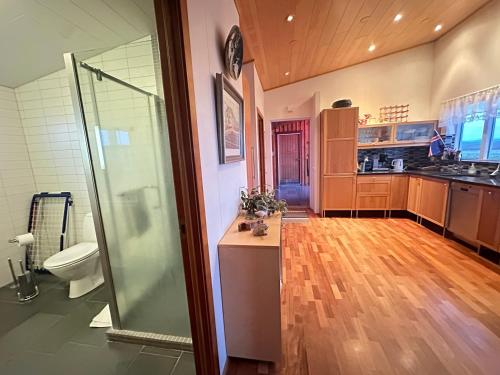 a large bathroom with a shower and a toilet at Steinsholt - Birta Rentals in Hella