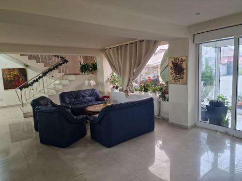 a living room with two blue couches and a table at Eden in Timişoara