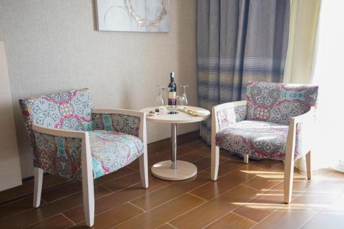 a table and two chairs and a white table and chairs at Xanadu Makadi Bay - High Class All Inclusive in Hurghada