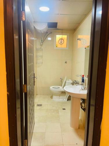 a bathroom with a toilet and a sink at Studio R6 in Abu Dhabi