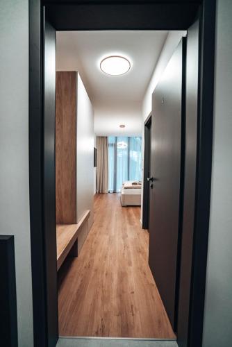 a hallway with a door open to a room with a bed at Jamy House in Habovka