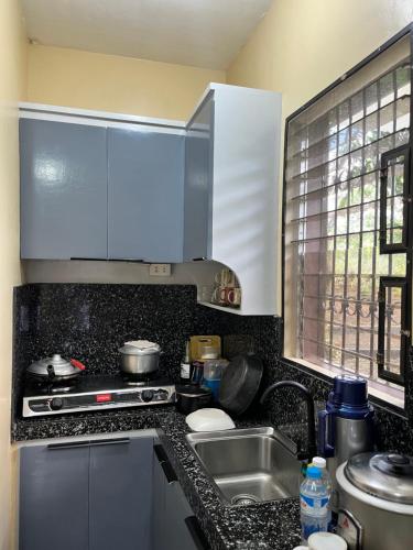 a kitchen with a sink and a counter top at The Quiet Villa in Tagaytay