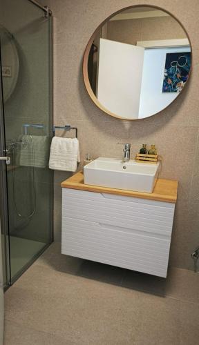a bathroom with a sink and a mirror at AGAETE PARADISE in Puerto de las Nieves