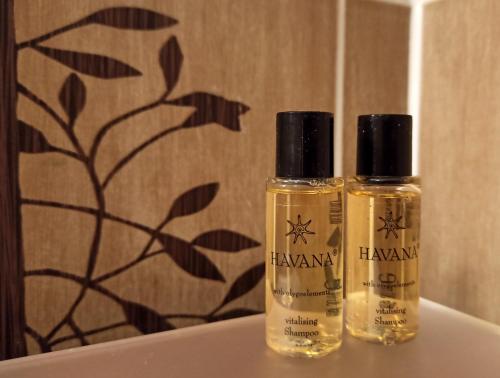 two bottles of essential oils sitting on a sink at Apartaments Gory in Niedzica Zamek