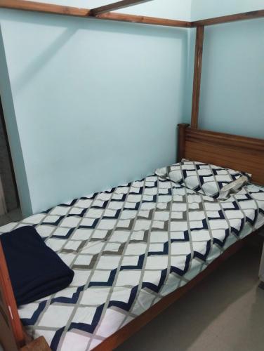 an empty bed in a room with at Srinilayam in Mysore