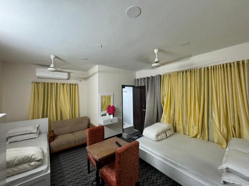 a hotel room with a bed and a couch at Hotel In Need - Near to the US France Italy Saudi Embassy and Airport in Dhaka