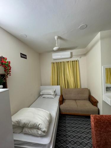 a small room with a bed and a couch at Hotel In Need - Near to the US France Italy Saudi Embassy and Airport in Dhaka