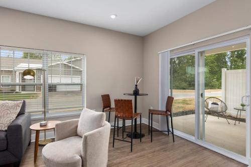 a living room with a couch and a table and chairs at Modern 2BR 2BA New Build Condo with Garage & Patio in Wyoming