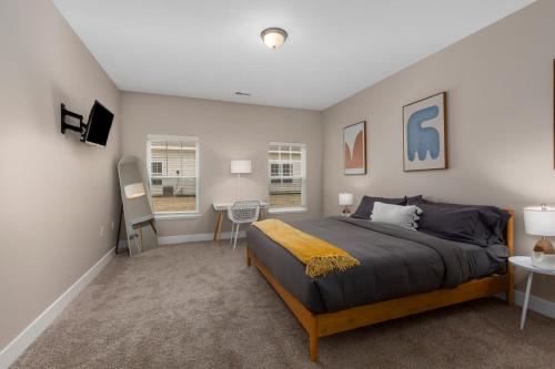 a bedroom with a large bed and a table and chairs at Modern 2BR 2BA New Build Condo with Garage & Patio in Wyoming