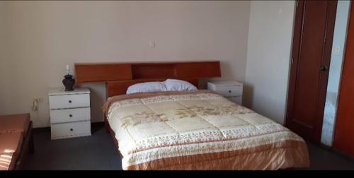 a bedroom with a bed and two night stands at Alojamiento Punta Negra in Punta Negra