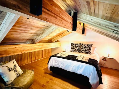 a bedroom with a bed in a room with wooden walls at Swiss Chalet Clarens in Clarens