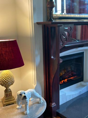 a toy dog sitting on a table next to a fireplace at Convent at Koroit in Koroit