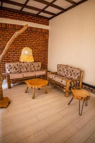 a living room with a couch and two tables at KABA Local Rwandan Guesthouse Entire Property for you with Tour services in and out the city such as Safari's in Kigali