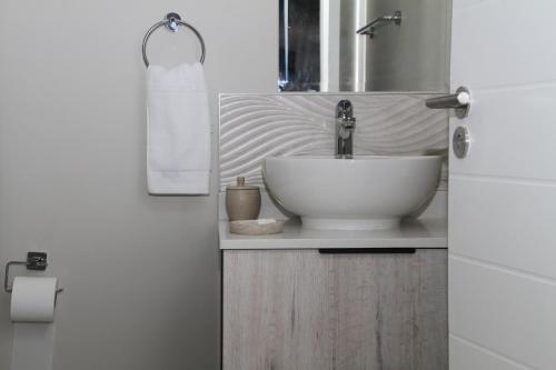 a bathroom with a bowl sink and a mirror at Urbane- By LaSerene -Carlswald in Midrand