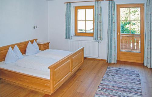 a bedroom with a bed with white sheets and a window at Nice Apartment In Hainzenberg With House A Mountain View in Zell am Ziller